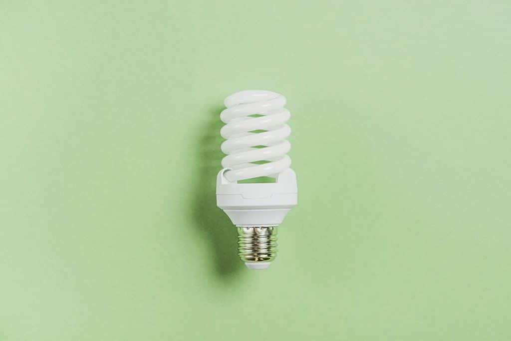 compact fluorescent light bulb green background